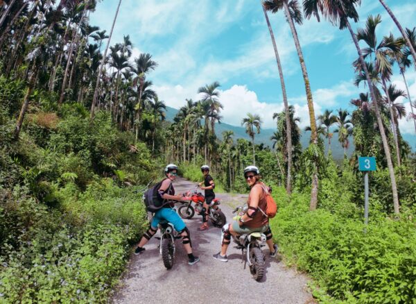 three foreign travellers are enjoying the time riding motocross on the Guangfu trail.